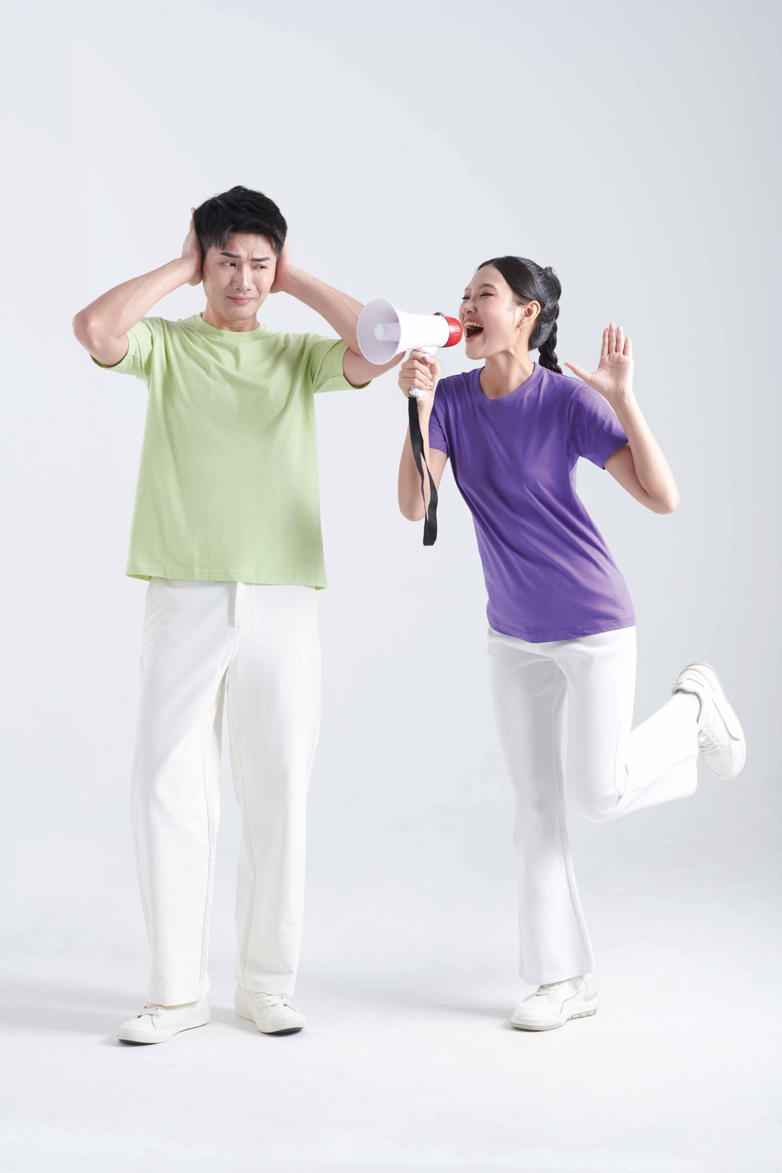 Two people wearing CT 51 unisex comfy cotton t-shirts in green and purple