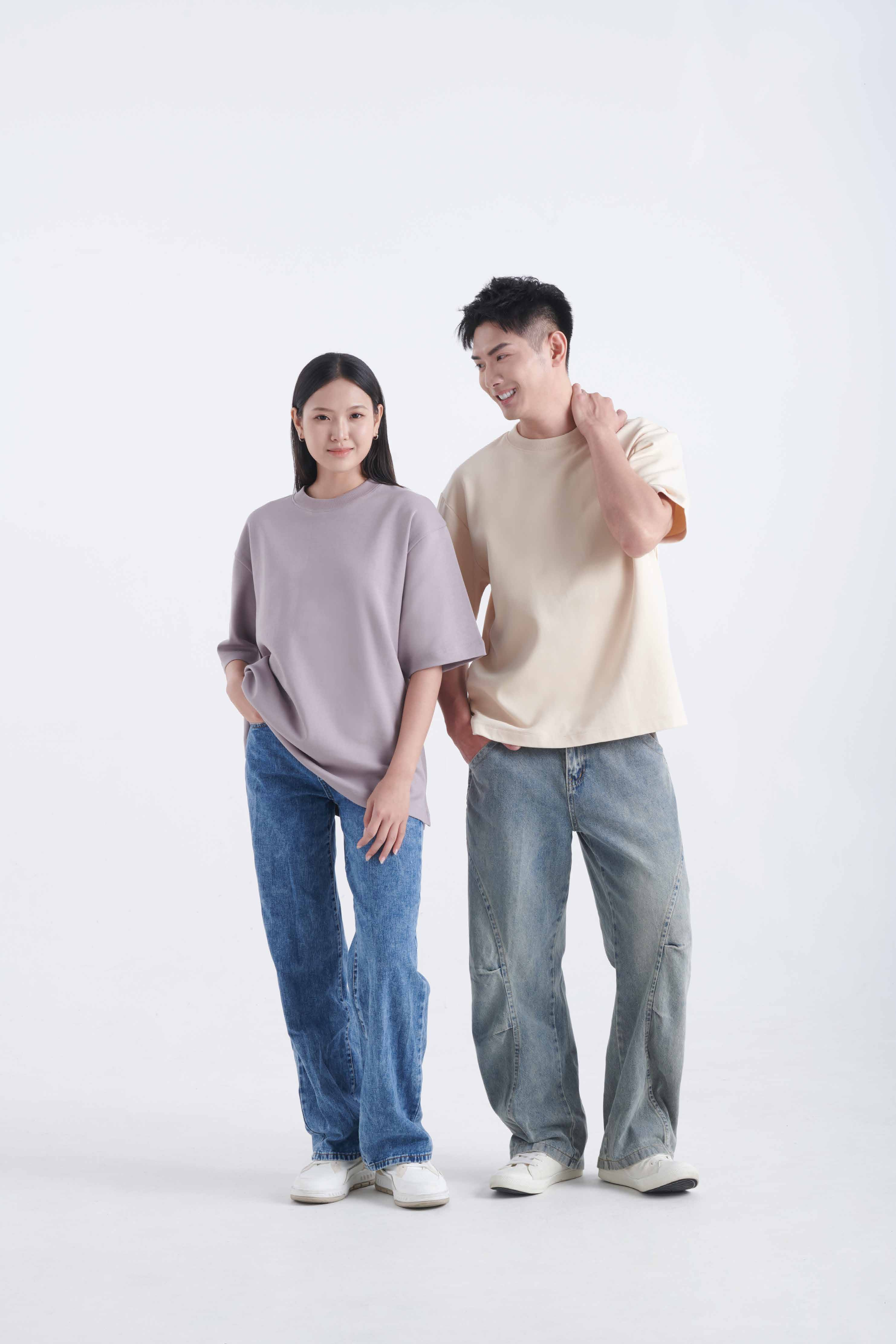 Two people wearing OT 03 unisex premium oversized t-shirts in lilac and cream