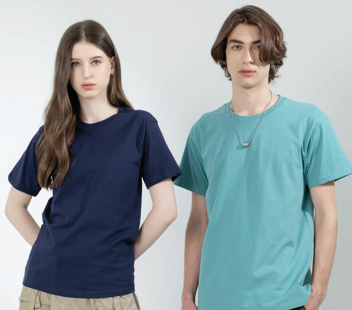 Two people wearing Gildan Hammer HA00 heavyweight tees in navy and seafoam