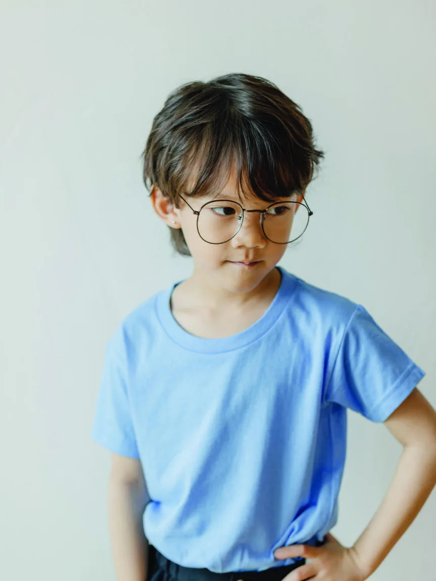 A boy in glasses wearing a light blue Gildan 76000B youth tee