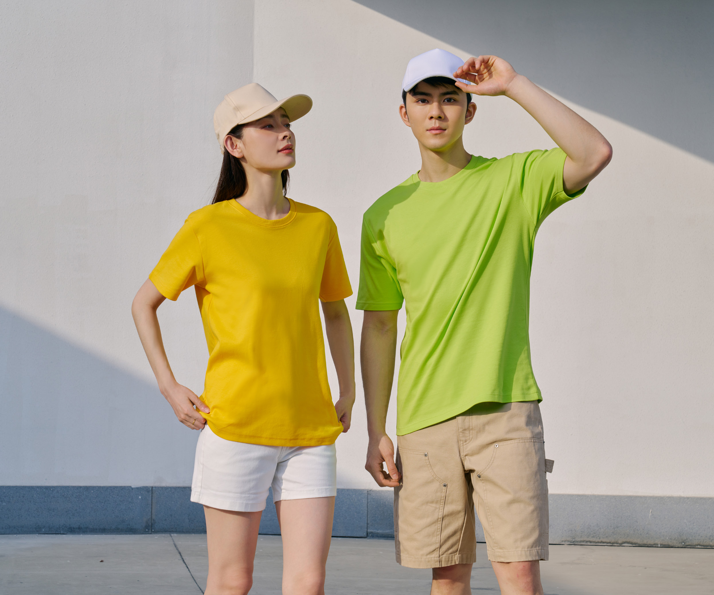 Two people wearing Le'Fonse RC06 round neck cotton t-shirts in yellow and lime green