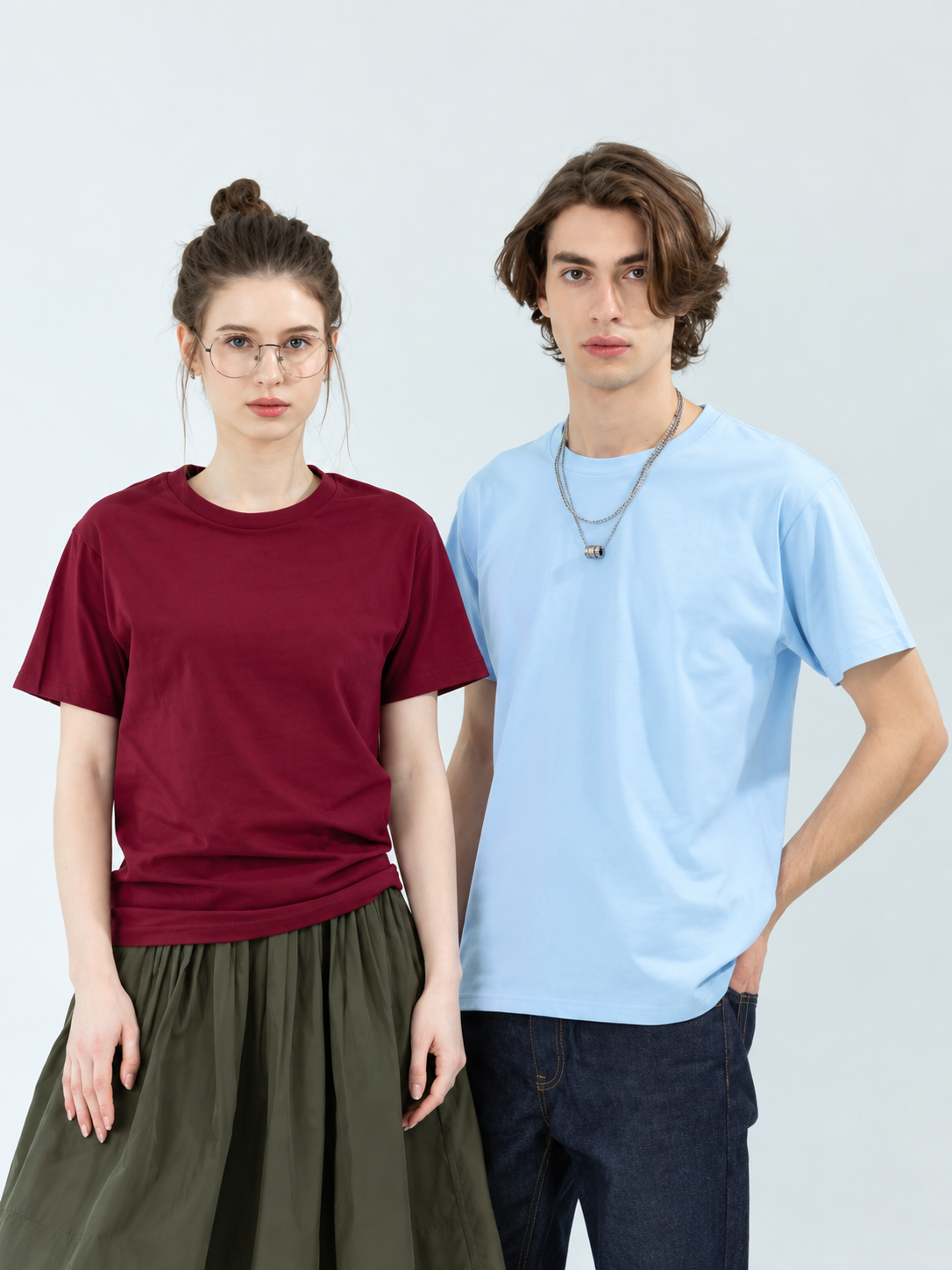 Two people wearing Gildan 76000 round neck cotton t-shirts in maroon and light blue