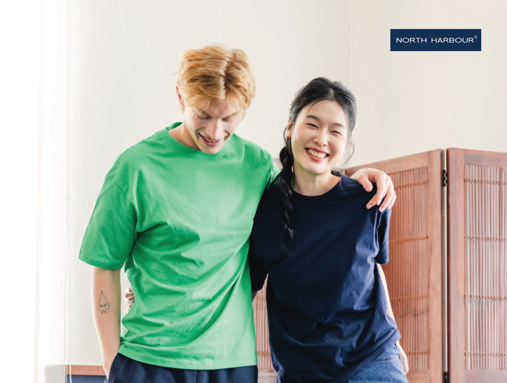 Two people wearing North Harbour NHR1100 round neck cotton t-shirts in green and navy