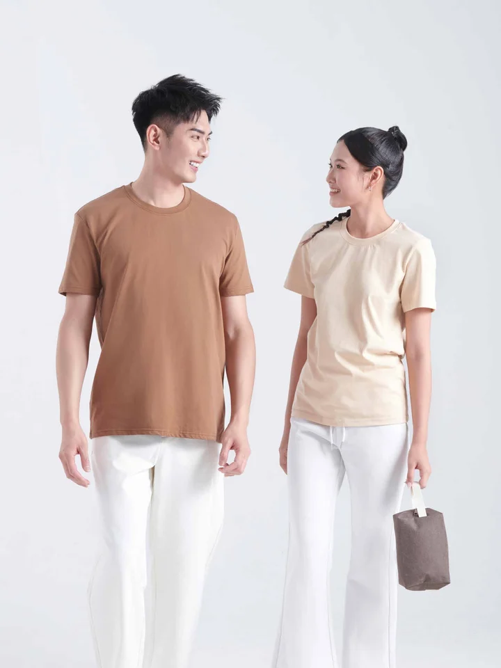 Two people wearing round neck tees in brown and beige